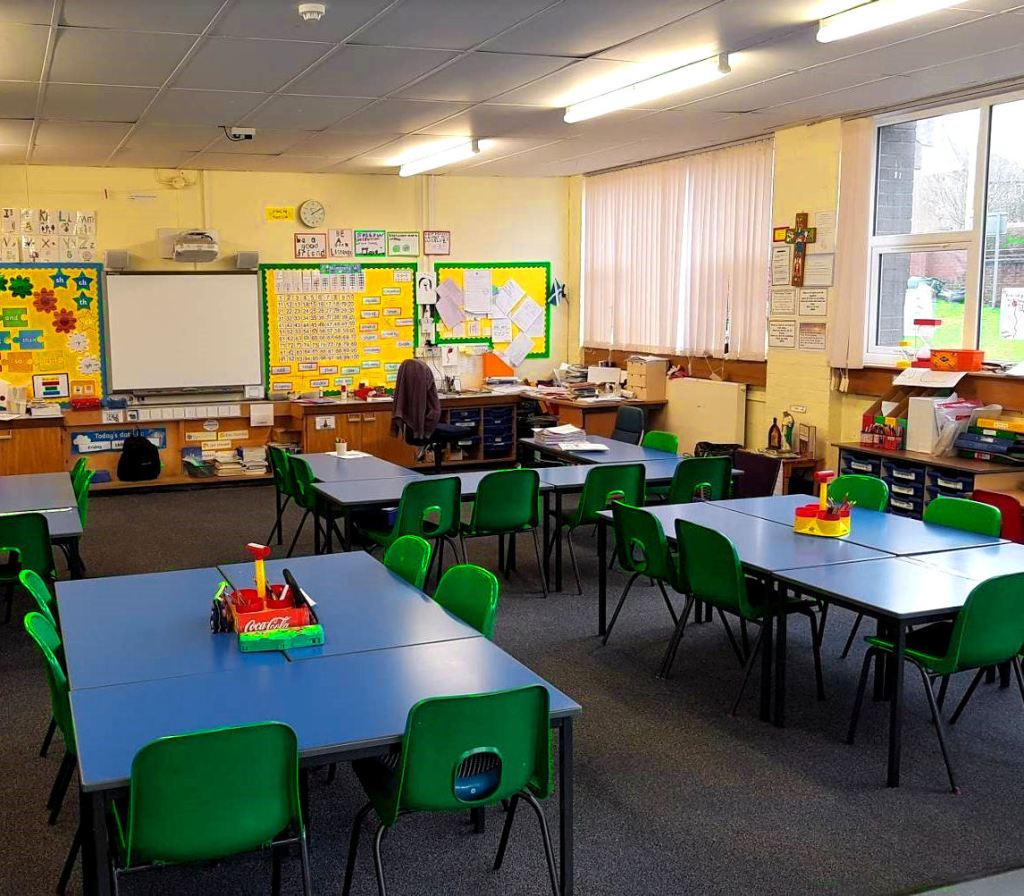 the tables are being laid out in different ways, three are in big groups and one shaped like a U