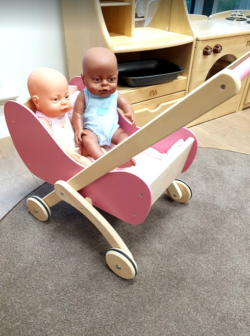 Two dolls in a pram in the home corner at Granton Early Years Centre