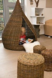 a child reads alone in a tipi