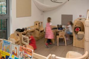three children play in the home corner