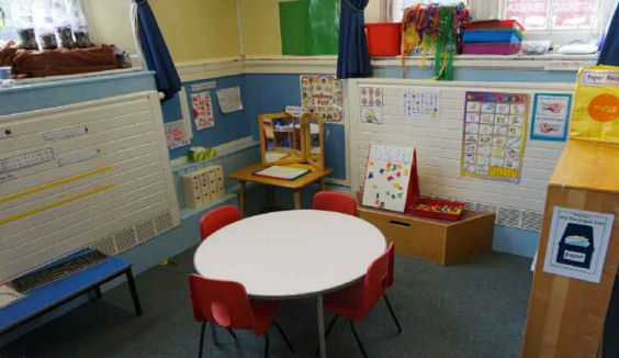 A break out space in a corner of the room with a table and chairs