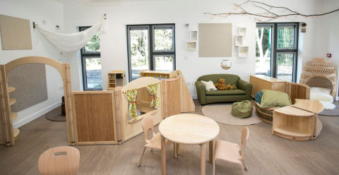 natural wooden furniture, decorative branch on the wall, dividers break up the space