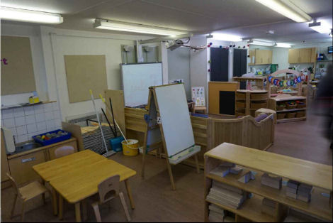 a block play cabinet and an art area next to a teaching area