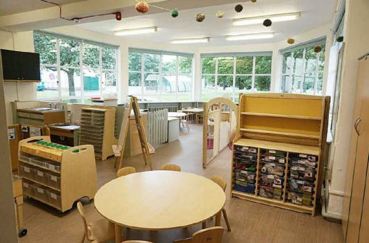 the furnishings are wooden, a large circular table with seats and lots of good storage