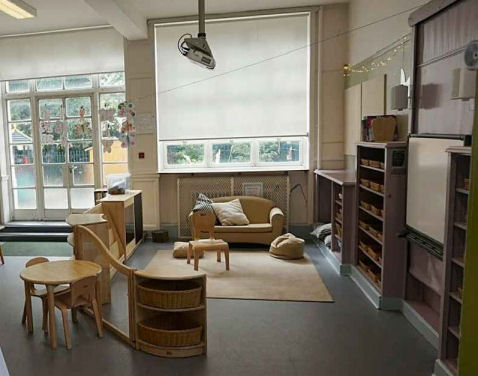 the teaching area looks like a living room with a sofa and a rug