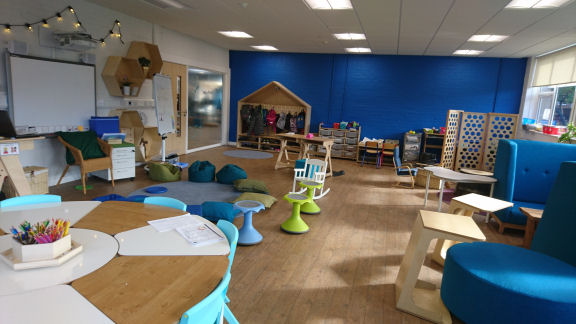 Flexible furniture, comfy seats, a blue wall can be used as a "green screen"