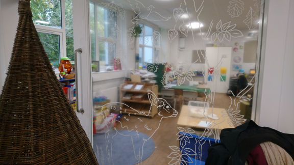 The woodland illustration on the Ferry Glen classroom sliding door