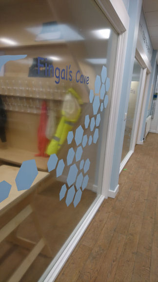 graphic of hexagons on the window to the classroom