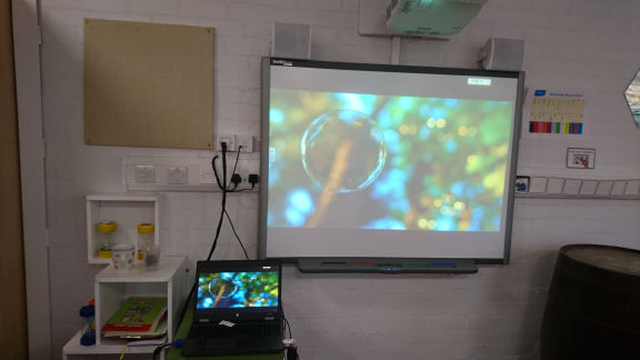 An interactive screen, cube shelving and fabric pinboard