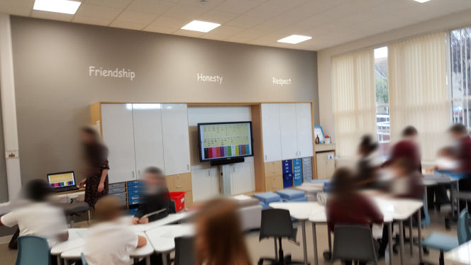 A teaching wall with whiteboard cupboards