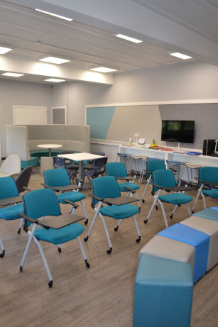 rows of chairs with flip over writing tables