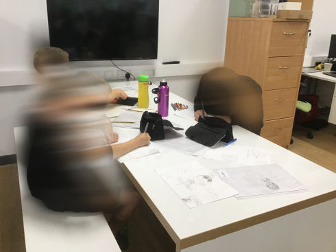 children working at a big work bench