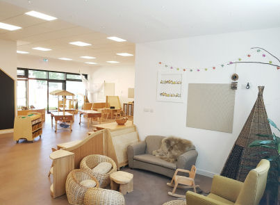 a cozy corner with the sofa and teepee, behind is the creative area