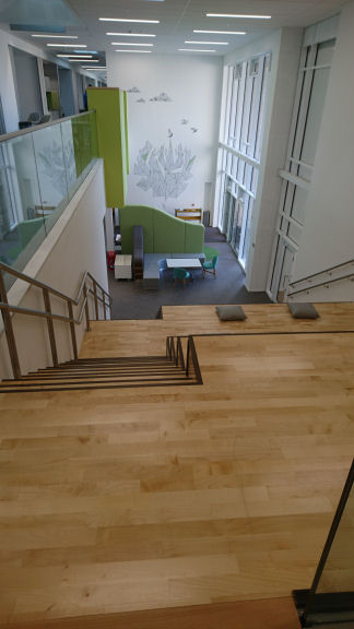 Steps and seating leading down to a shared breakout space