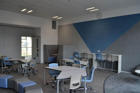 the classroom has decorative pinboarding and flexible furniture