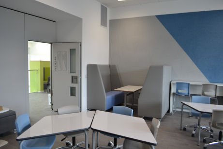 A high up table and booth allow collaborative working away from the group