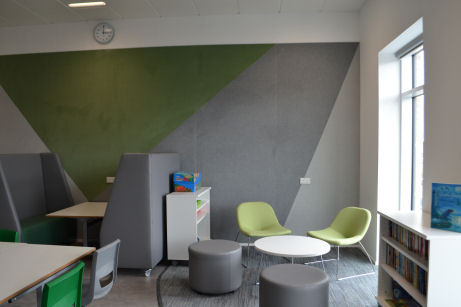 collaborative spaces, comfy chairs and stools around a circular coffee table, a booth with high backed sofas gives some privacy