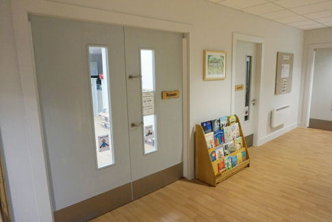 a bookshelf full of books outside the classroom