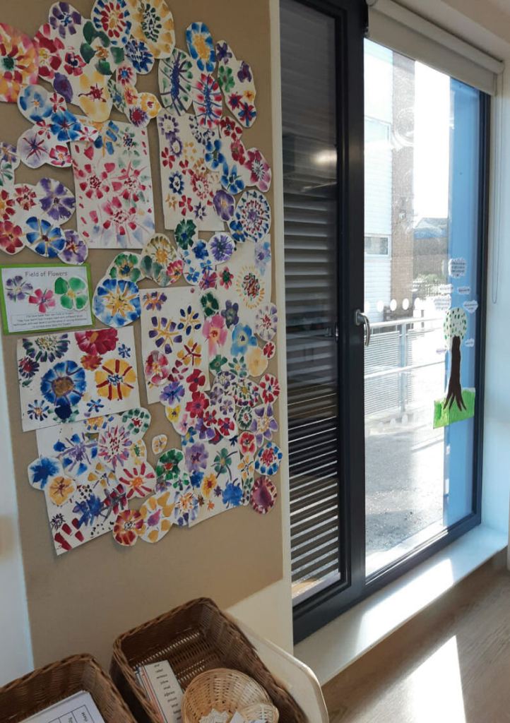 The children's artwork provides the colour on this display board with bright painted flowers
