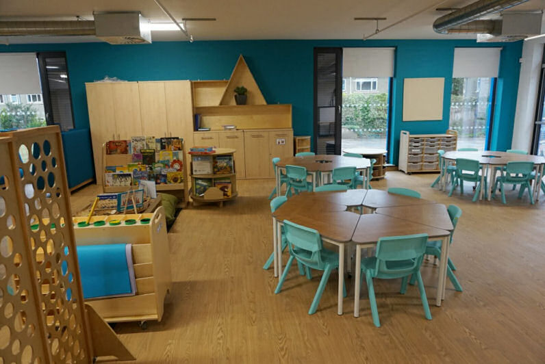 three tables to sit six children each are made up of individual triangular desks that can join together