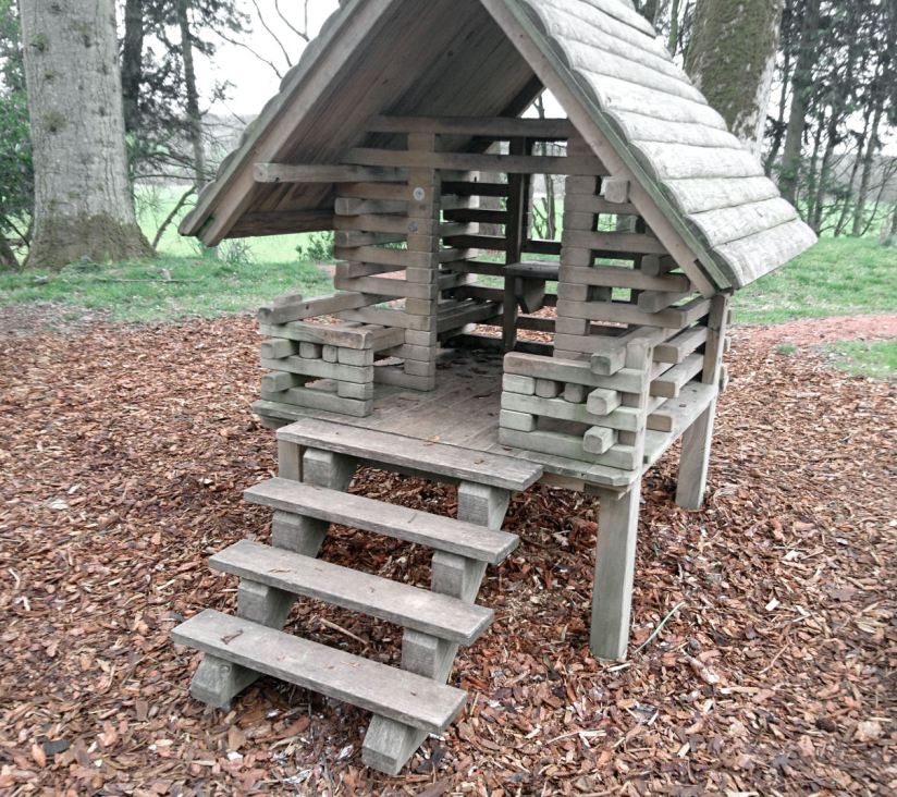 a child's small wooden hut, raised on stilts with a ladder going up to the doorway
