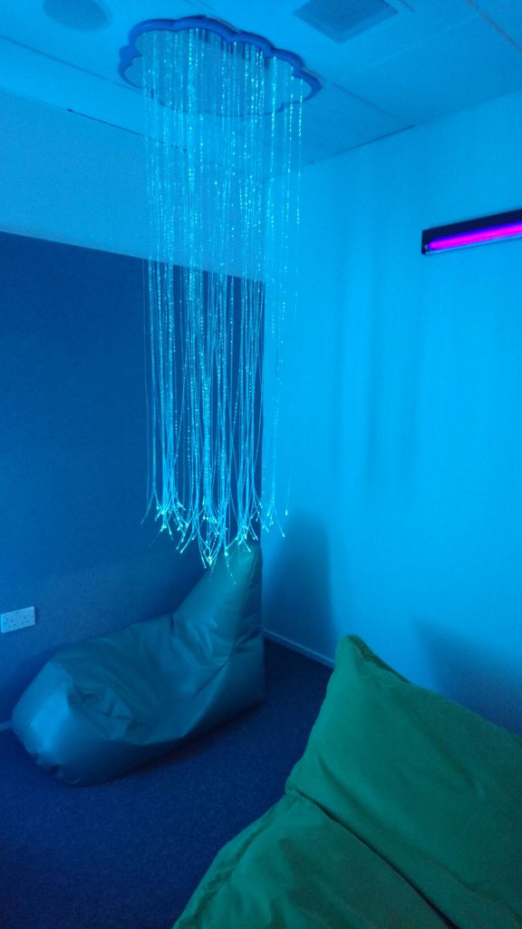There are a couple of beanbags on the floor and a fibre optic curtain hangs from the ceiling