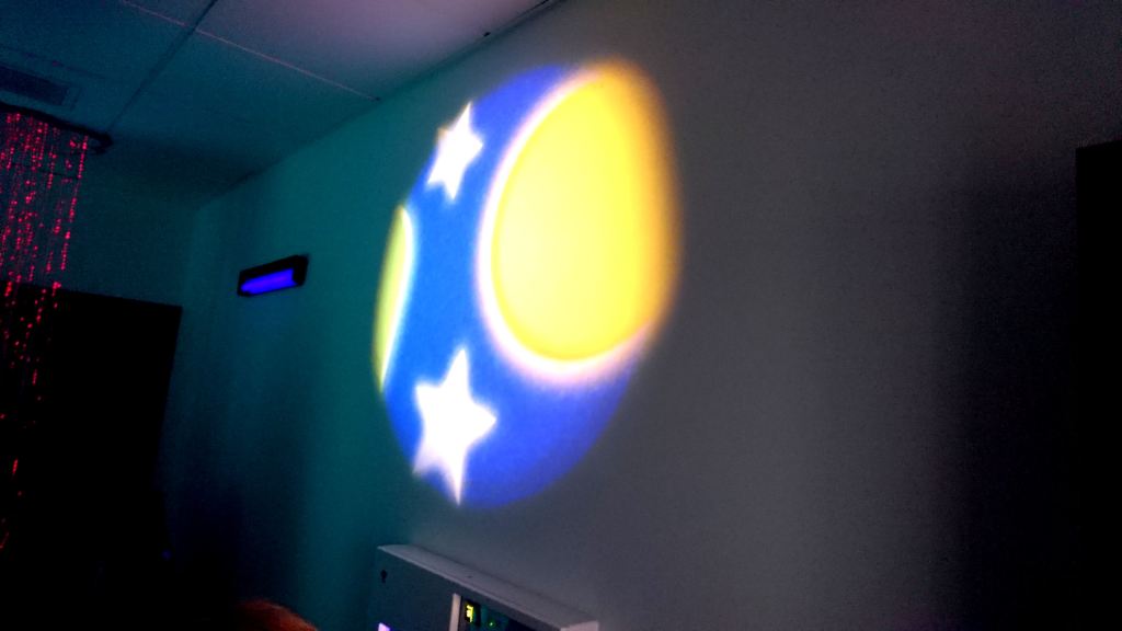 A projection of the moon and stars on the wall