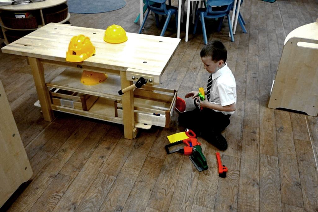 a boy works at the construction bench