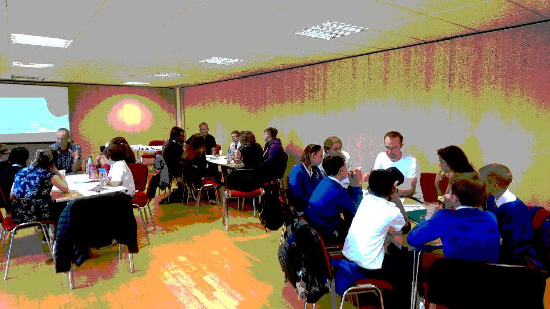 3 groups of learners chatting to professionals about their designs