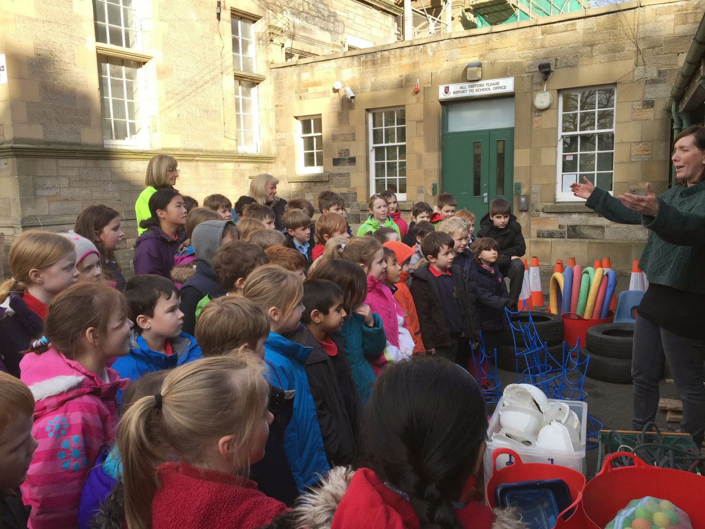 A trainer is explaining to staff and children all about loose parts
