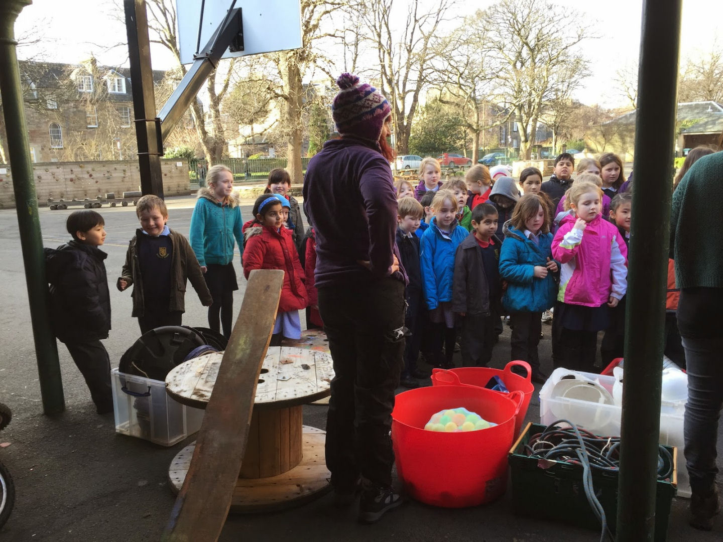 Children are listening to a talk about how to use loose parts
