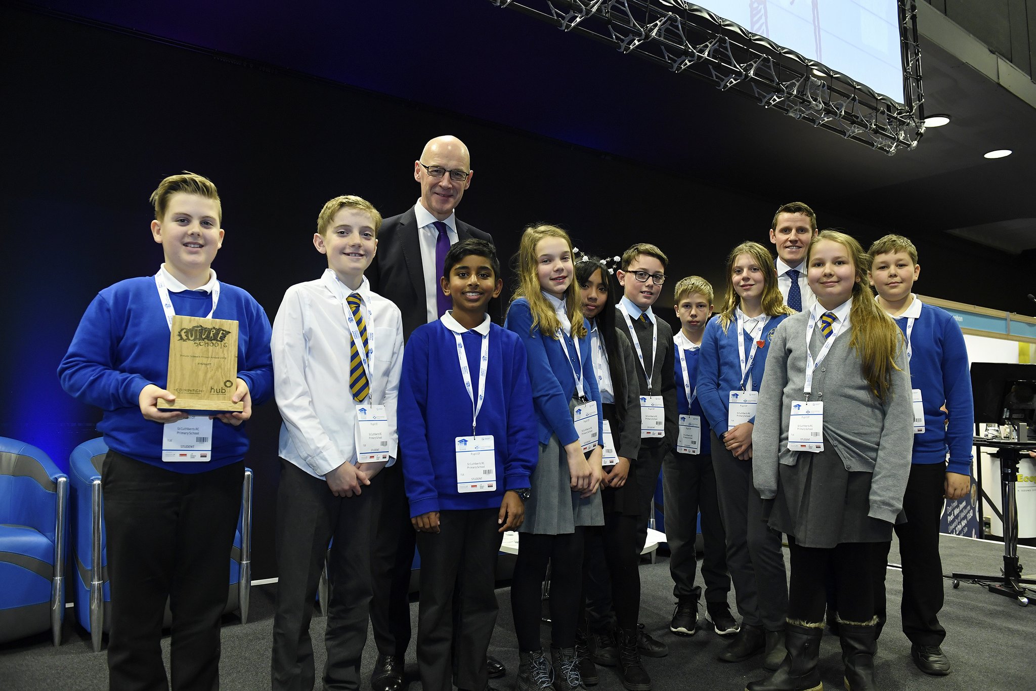 Ten children from St Cuthbert's primary pose with their trophy alongside Depute First Minister John Swinney, and Richard Park from HUB South East