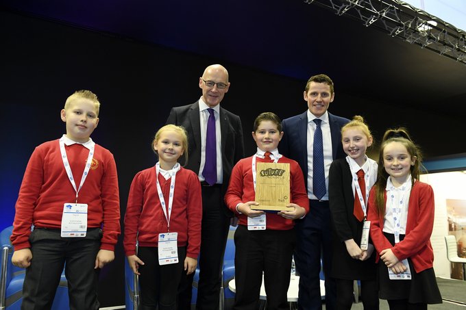 five children from St John Vianney's primary pose with their trophy alongside Depute First Minister John Swinney, and Richard Park from HUB South East