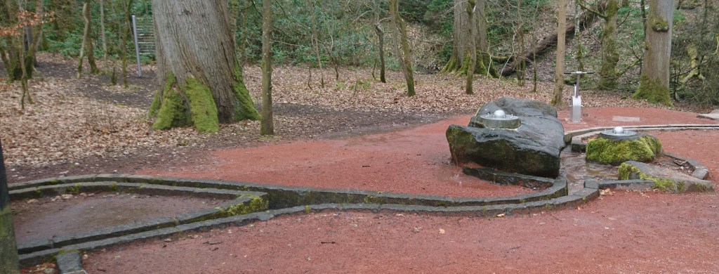 a man made water course with rocks goes to the stream