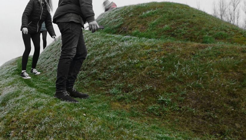 people walking on a mound