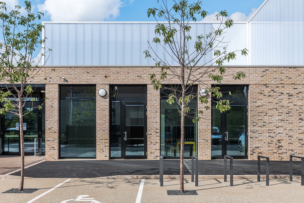 Building from the car park, trees and bicycle rack