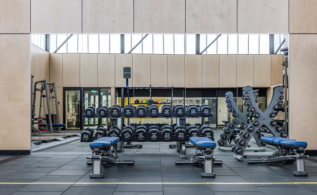 Large mirror in the fitness suite with weight lifting equipment in front