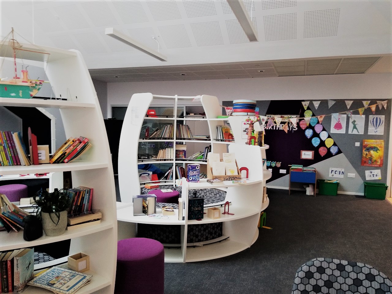 curved white bookshelves